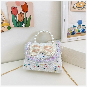 Detail of tweed girls handbag with pearl bow, sequin lace and beaded handle