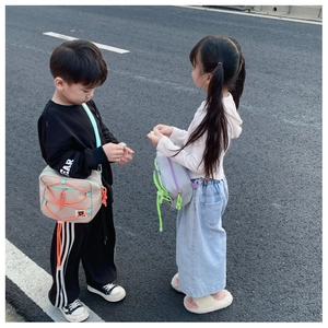 Kids outdoor style crossbody bags with drawstring design shown on a child model outdoors