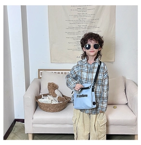 Kids light blue canvas crossbody bag with Freedom letters styled with checkered shirt