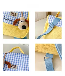 Detail view of checkered quilted kids backpack with cute dog pendant and adjustable straps