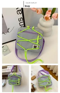 Detail of gray nylon kid crossbody bag with neon elastic cords and cute bear patch