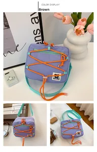 Purple nylon kids crossbody bag with orange elastic cords and cartoon MF BEAR patch detail