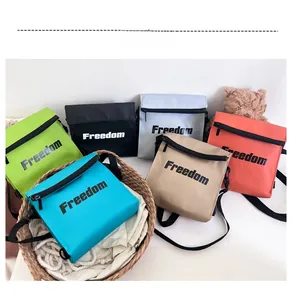 Close-up of nylon kids crossbody bags in six vibrant colors with Freedom text print