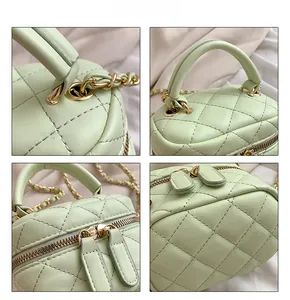 Detail view of light green quilted mini handbag with dual zippers and chain strap
