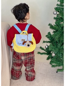 Detailed back view of quilted yellow toddler backpack with cute 3D cartoon dog and plaid flap