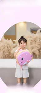 Pink whale shaped kids EVA hard shell backpack shown with a child model for school