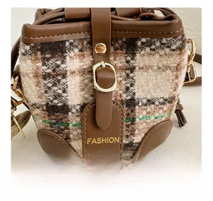 Close-up of winter quilted pattern texture with premium brown leather trim and metal clasp
