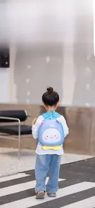 Detail showing toddler cartoon backpack with cute facial expression and yellow trim accents