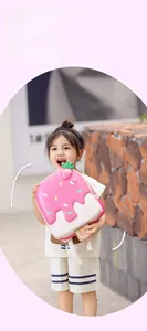 Detailed view of a pink ice cream shaped kids backpack with 3D strawberry detail