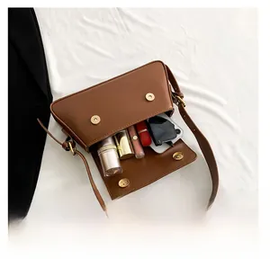 Practical storage capacity of brown leather shoulder bag with phone and sunglasses
