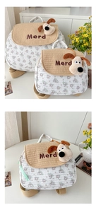 Detail of quilted kid's backpack featuring embroidered plush puppy and corduroy flap