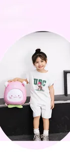 Detail of pink cartoon peach hard shell backpack with cute facial expression for kids