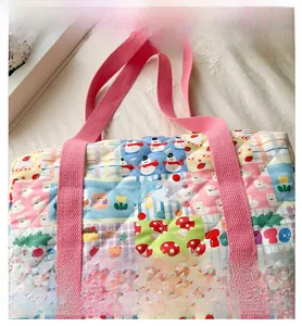 Detail of quilted kids crossbody bag with cute floral patterns and bunny motifs