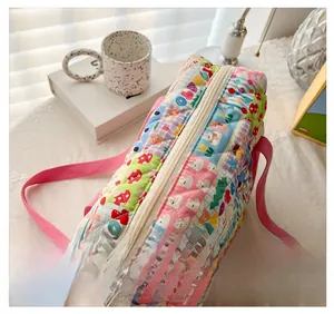 Quilted cotton floral bag detail with cartoon rabbit, strawberry patterns and pink strap