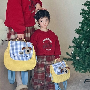Quilted yellow kids backpack with blue checkered flap and cute plush puppy charm