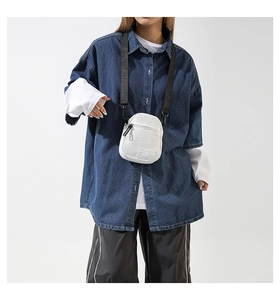 Sac bandoulière en velours côtelé blanc porté par un mannequin avec patch Fashion