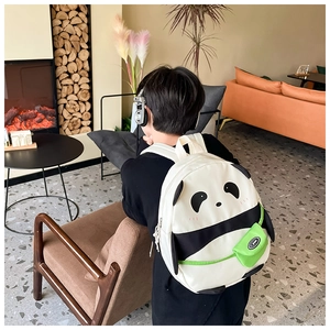 Detail of cute panda backpack for kids featuring soft fabric and a green sport pouch