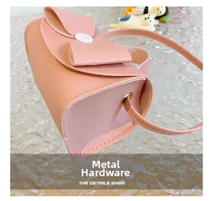 Detail view of pink mini bag featuring hardware grommet and a large decorative bow