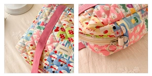 Close-up of quilted floral kids crossbody bag with strawberry prints and zipper detail