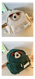 Detail of corduroy backpacks in cream and dark green with cute cartoon dog 3D plush decor