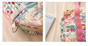 Close-up of quilted floral kids bag featuring zipper detail and metal D-ring attachment