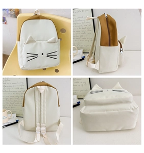 Detail view of cartoon cat backpack showing side pockets and adjustable straps