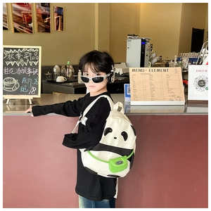 Detail view of a cute panda backpack on a toddler, featuring canvas fabric and green pocket