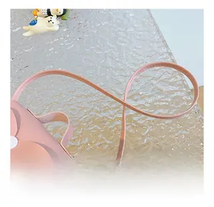 Detail view of the pink faux leather shoulder strap with durable stitching on kid's bag