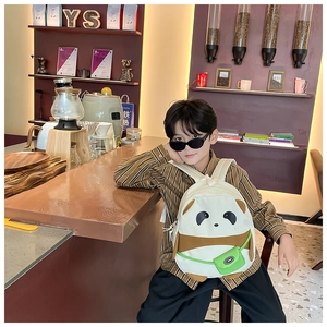 Detail of cute panda backpack with 3D ears and mini green sport bag on a child