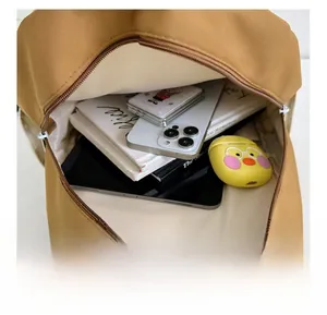 Detailed interior view of a kids cartoon backpack showing capacity with a tablet and books