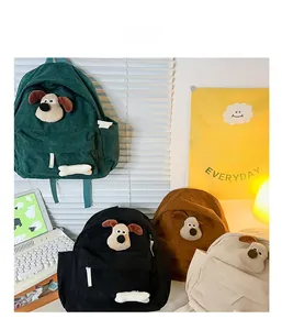 Detailed view of corduroy children backpack featuring 3D cartoon dog and bone decorations