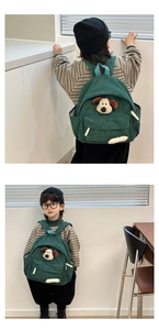 Green corduroy kids backpack featuring a plush cartoon puppy and side storage pocket