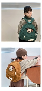 Detail of corduroy kids backpack featuring a plush 3D puppy face and soft ribbed texture
