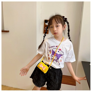 Close-up of bright yellow mini crossbody bag with a pink bow on a child fashion outfit