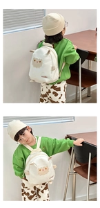 Detail view of cute sheep embroidery and 3D ears on a white canvas kid's backpack