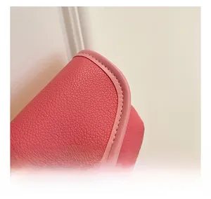 Close-up of pink lychee pattern leather texture and fine stitching on a girl mini bag