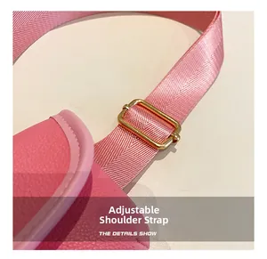 Close-up of pink PU leather bag detail featuring an adjustable shoulder strap with gold buckle
