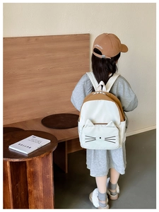 Detail of children's cartoon cat backpack featuring 3D ears and contrast color design