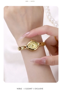 Close-up of elegant gold vintage bracelet watch with twisted link chain and oval dial