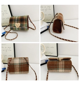 Detail view of plaid mini crossbody bag featuring a golden heart lock and chain strap