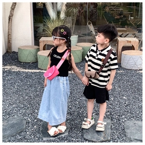 Kids fashion crossbody bags shown on models in a stylish outdoor casual setting