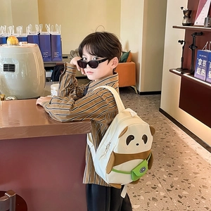 Cute panda-shaped kids backpack for school in cream and brown with a mini green pouch