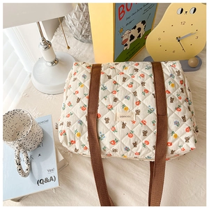 Detailed shot of floral bear quilted bag with handles in a cozy home setting decor