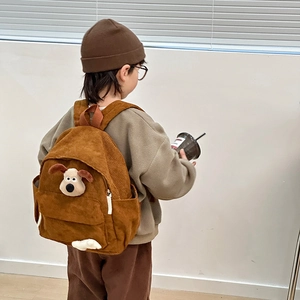 Brown corduroy kids backpack featuring a 3D plush cartoon dog decoration on the back