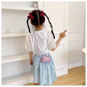Girl's purple PU leather mini crossbody bag with cute bow detail shown on child model