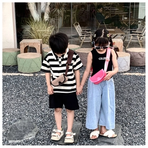 Outdoor street shot of kids wearing trendy mini PU cross-body bags and fashion outfits