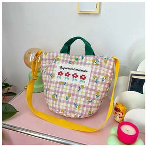 Détail du sac cabas matelassé à carreaux avec broderie florale et anses en tissu vert