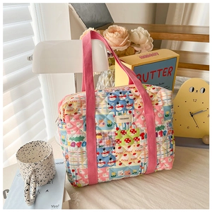 Close-up of quilted floral crossbody bag for girls with cute bear and snowman patterns