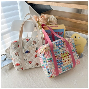 Detailed macro view of floral quilted cotton tote bags with animal and colorful prints