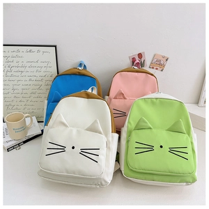 Detail view of four colorful cartoon cat backpacks with 3D ears and embroidered whiskers